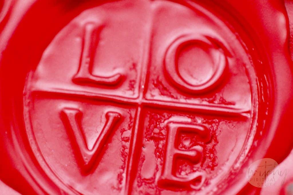 a wax seal with the words love on it that you would use in a love spell